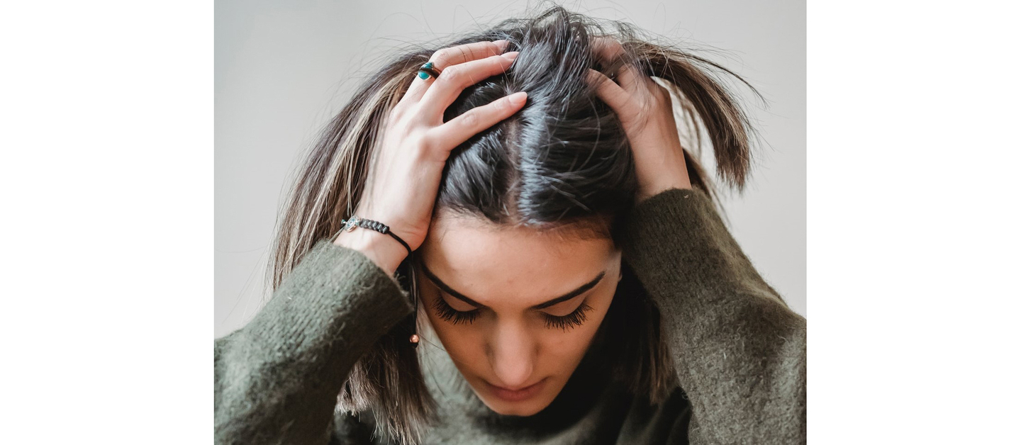 Anxious expression and tousled hair indicating washing frequency dilemma.